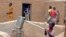 A child pumps water in the northern town of Kouroume, Mali, May 13, 2015.