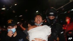 Israeli police officers arrest a protester during a demonstration against lockdown measures that they believe are aimed at curbing protests against Prime Minister Benjamin Netanyahu, in Tel Aviv, Israel, Oct. 3, 2020. 