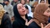 FILE - In this March 15, 2019, picture, Iraqi Yazidi women mourn during the exhumation of a mass grave in Iraq's northwestern region of Sinjar. 