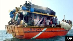 Sri Lankans asylum seekers stay on their traditional boat near Dili's port, July 31, 2002.