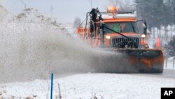 A snowplow clears snow off of Interstate 80 near Earlham, Iowa, Feb. 2, 2016. A winter storm that dumped heavy snow on Denver and much of Colorado has moved east into Nebraska and Iowa.