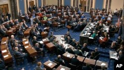 In this image from video, senators vote on the first article of impeachment during the impeachment trial of President Donald Trump, in the Senate at the U.S. Capitol in Washington, Feb. 5, 2020. 