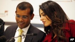 British lawyer Amal Clooney, right, talks with former Maldives president Mohamed Nasheed during a press conference in London, Monday, Jan. 25, 2016.