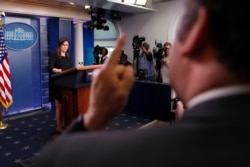 FILE - Brian Karem, right, White House correspondent for Playboy magazine, gestures as he reacts to responses by then-White House press secretary Sarah Huckabee Sanders, left, during a daily briefing at the White House, in Washington, June 14, 2018.