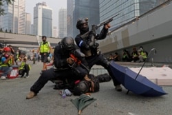 Police detain protesters during the demonstration in Hong Kong, Sept. 29, 2019.