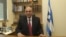 Shaul Mofaz, head of the centrist Kadima party, poses for a photo in his office at parliament in Jerusalem, before he was sworn in as a cabinet minister.