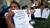 FILE - Victims of the Khmer Rouge regime hold a protest to demand individual reparations in front of an entrance to the U.N.-backed war crimes tribunal as a hearing is held in Phnom Penh, Cambodia, Oct. 17, 2014. 