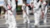 South Korean soldiers wearing protective gear sanitize a street in front of the city hall after the rapid rise in confirmed cases of the novel coronavirus disease of (COVID-19) in Daegu, southeast of the capital Seoul, South Korea, March 2, 2020. …