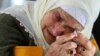 A Bosnian Muslim woman reacts as she awaits the final verdict of former Bosnian Serb military leader Ratko Mladic in the Srebrenica-Potocari Genocide Memorial Center, Bosnia and Herzegovina.