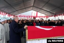 Turkey's President Tayyip Erdogan speaks during the funeral of Turkish soldier Emre Baysal who was killed in Syria's Idlib region, in Istanbul, Turkey, Feb. 29, 2020.