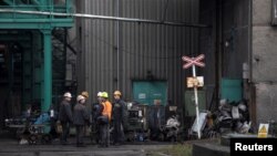 Miners stand at a compound of the CSM hard coal mine after a methane explosion near the town of Karvina, Czech Republic, December 21, 2018. 