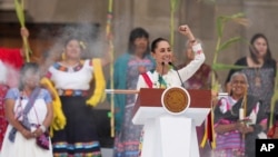 Mexico's President Claudia Sheinbaum addresses supporters during a rally in the Zocalo, Mexico City's main square, on her inauguration day, Oct. 1, 2024.