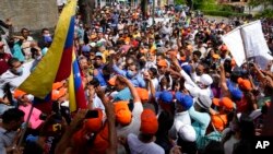 Opposition leaders Juan Guaido, center left, and Freddy Superlano, greet supporters during a demonstration in support of Superlano in Barinas, Venezuela, Dec. 4, 2021.