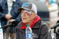 Former President Jimmy Carter answers questions during a news conference at a Habitat for Humanity project, Oct. 7, 2019, in Nashville, Tenn. Carter wears a bandage after a fall the day before at his home in Plains, Ga.