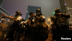 Riot police prepare their gear during a demonstration against a proposed extradition bill in Hong Kong, June 12, 2019. 