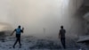 People and a journalist rush toward the scene of an explosion following an Israeli strike which reportedly targeted a school in the Zeitoun district on the outskirts of Gaza City, on Sept. 1, 2024.