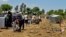 This July 5, 2018 photo provided by Nabaa Media, a Syrian opposition media outlet, shows people who fled from Daraa province, gathering in the Quneitra countryside, near the Israeli-occupied Golan Heights. 