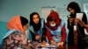 FILE - Afghan election commission workers count ballot papers for the presidential election in Kabul, Afghanistan Sept. 28, 2019.