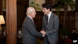 Britain's King Charles III, left, meets Canadian Prime Minister Justin Trudeau at the Sandringham Estate in Norfolk, England, March 3, 2025. 