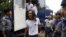 Student activist Min Thway Thit arrives at a mass trial of student protesters at Tharrawaddy court, Tharrawaddy, Bago division July 28, 2015