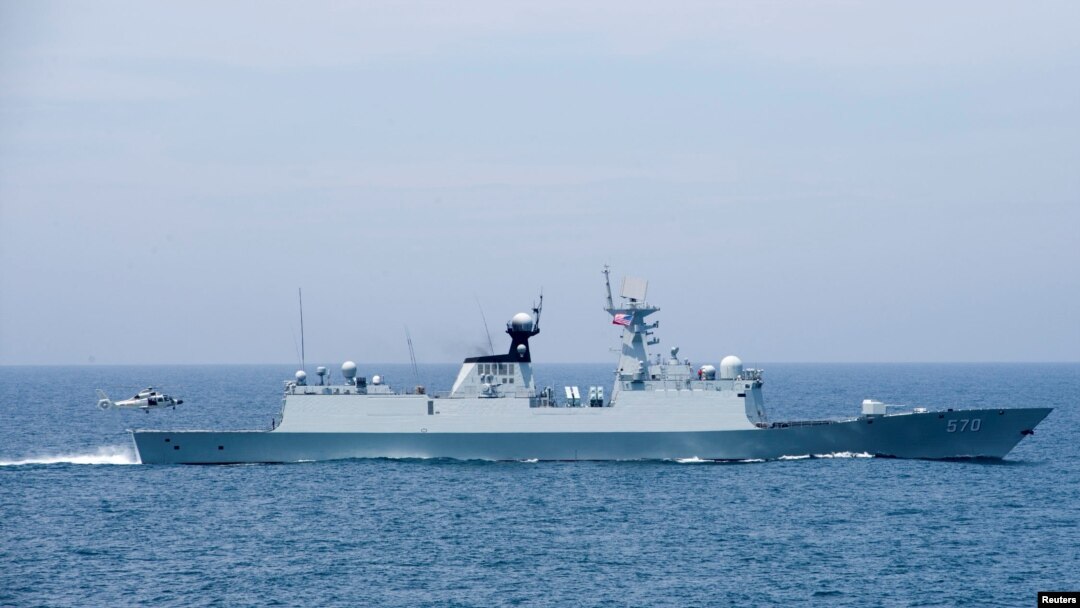 A Chinese naval Z-9 helicopter prepares to land aboard the PeopleÕs Liberation Army (Navy) frigate CNS Huangshan (FFG-570) as the ship conducts a series of maneuvers and exchanges with the Arleigh Burke-class guided-missile destroyer USS Sterett …