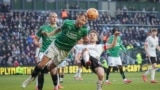 Plymouth Argyle's Nikola Katic, left, clears the ball next to Liverpool's Diogo Jota during the English FA Cup fourth round soccer match between Plymouth Argyle and Liverpool at Home Park stadium in Plymouth, England, Feb. 9, 2025.