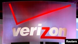 FILE - A Verizon sign is seen displayed at an electronics show.