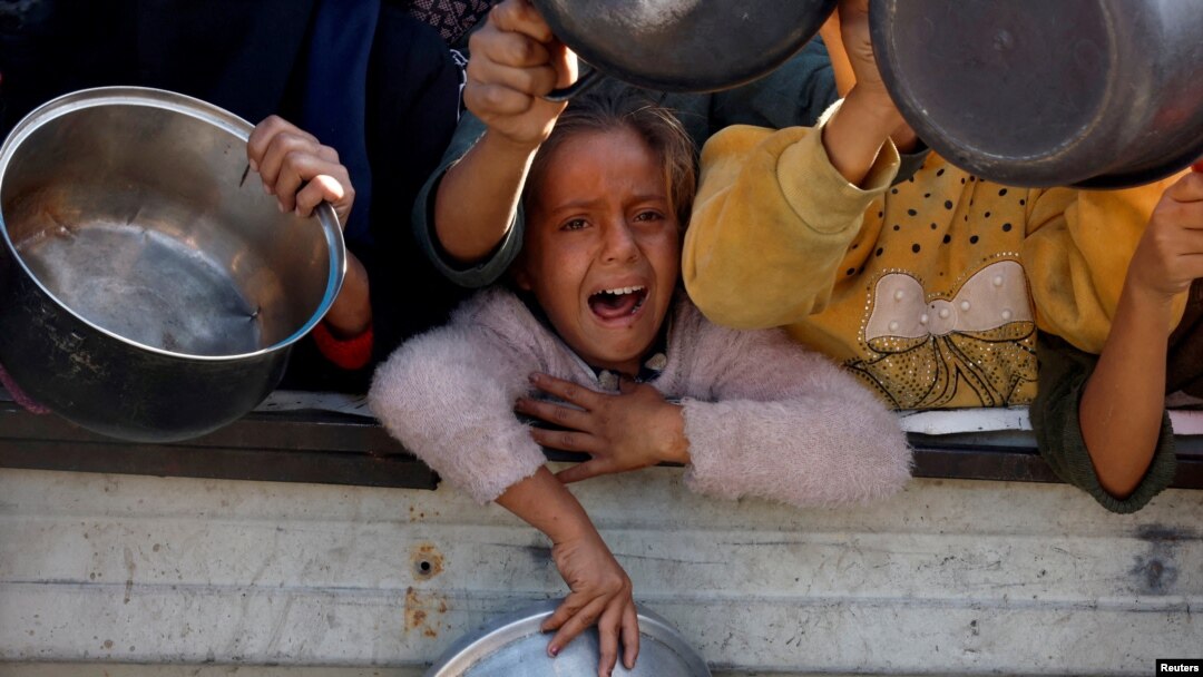 Palestinians in Khan Younis clamor for food from a charity kitchen during a hunger crisis in the southern Gaza Strip, Dec. 4, 2024.