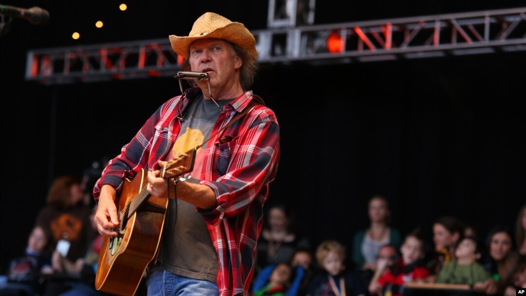 FILE - Neil Young performs at the Bridge School Benefit Concert at the Shoreline Amphitheatre in Mountain View, Calif., Oct. 20, 2012.