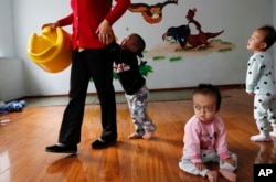 FILE - Children at a foster home of the New Hope Foundation on the outskirts of Beijing, Oct. 11, 2017.