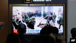 FILE - A TV screen at Seoul Railway Station in South Korea, on Oct. 21, 2024, shows an image of soldiers believed to be from North Korea standing in line to receive supplies from Russia.