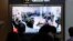 FILE - A TV screen at Seoul Railway Station in South Korea, on Oct. 21, 2024, shows an image of soldiers believed to be from North Korea standing in line to receive supplies from Russia.