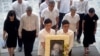 FILE - In this Sunday, March 29, 2015, file photo, the family members second row left to right; Lee Suet Fern, son Lee Hsien Yang, son Lee Hsien Loong, Ho Ching and Lee Wei Ling, daughter of the late Lee Kuan Yew, arrive with his portrait at the start of the state funeral. 