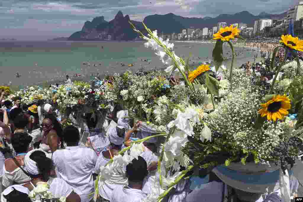 Believers make offerings during the celebration of Iemanja, in Rio de Janeiro, Brazil.