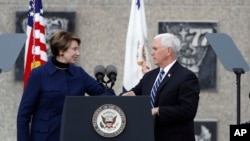 U.S. Secretary of the Air Force Barbara Barrett bumps elbows to greet Vice President Mike Pence during the graduation ceremony for the class of 2020 at the U.S. Air Force Academy in Colorado, April 18, 2020.