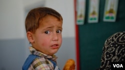 A young Syrian boy looks apprehensive as he awaits a vaccination in Arsal, Lebanon, Sept. 29, 2012. (VOA/J. Neumann)