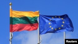 FILE - Lithuanian and European Union flags flutter at the Sudargas border crossing point with Russia in Ramoniskiai, Lithuania, June 5, 2017. 