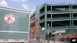 The tail end of the Red Sox team equipment truck crosses Yawkey Way outside Fenway Park, Feb. 5, 2018, in Boston. The truck was headed to the team's spring training facility in Fort Myers, Fla.