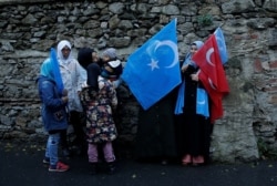 Ethnic Uighur women are seen during a protest against China near the Chinese Consulate in Istanbul, Turkey, Dec. 15, 2019.