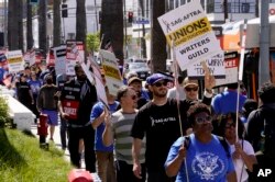 Members of the SAG-AFTRA join a picket line in support of the Writers Guild of America picket outside the Netflix, Inc., building on Sunset Blvd., in the Hollywood neighborhood in Los Angeles, May 2, 2023.