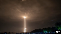 FILE - A Long March 5 rocket carrying China's Chang'e-5 lunar probe launches from the Wenchang Space Center on China's southern Hainan Island, November 24, 2020, on a mission to bring back lunar rocks.