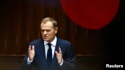 Poland's Prime Minister Donald Tusk gestures as he delivers a speech at parliament in Warsaw, August 27, 2014.