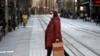 A woman crosses a normally busy street in Sydney, July 7, 2021.