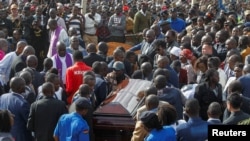 The coffin of Kenya's marathon world record holder Kelvin Kiptum, who died in a road accident, is carried to the gravesite at his home in Naiberi village, Uasin Gishu County, Kenya, February 23, 2024. 