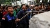 University students shout as they attempt to pull down the barricade during an anti-government protest called 'Indonesia Gelap' (Dark Indonesia) against the recent budget efficiency policies, near the presidential palace in Jakarta, Feb. 20, 2025. 