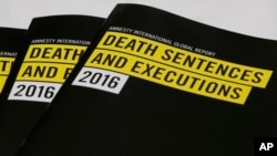 Copies of a report on the death penalty are displayed during a Amnesty International press conference in Hong Kong, April 10, 2017. 