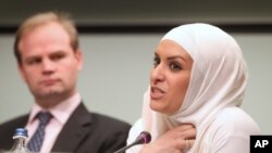 Belgium's Hejare Boujtat, right, testifies, as John Dalhuisen, Europe and Central Asia Deputy Programme Director at Amnesty International, looks at her, during a media conference, at the presentation of a report by Amnesty International called 'Choice and prejudice: discrimination against Muslims in Europe' in Brussels, Tuesday, April 24, 2012. 