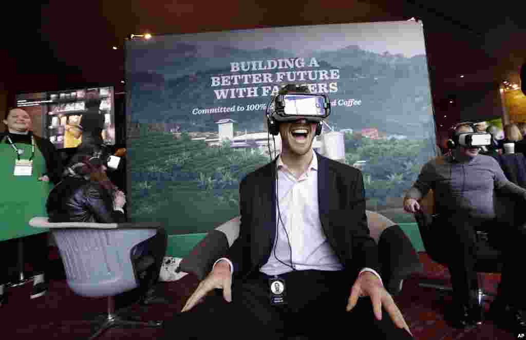 Starbucks employee Ed Devlin reacts as he views a 360 video of a Starbucks&#39; Costa Rica coffee farm at a display before the company&#39;s annual shareholder meeting in Seattle, Washington, March 22, 2017.