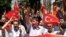 Turks hold national flags as they march in Ankara, Turkey to protest the killings of soldiers , Wednesday, June 20, 2012, a day after Kurdish rebels attacked Turkish military units with mortars and rocket-propelled grenades in the Daglica area of Hakkari