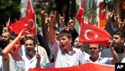 Turks hold national flags as they march in Ankara, Turkey to protest the killings of soldiers , Wednesday, June 20, 2012, a day after Kurdish rebels attacked Turkish military units with mortars and rocket-propelled grenades in the Daglica area of Hakkari